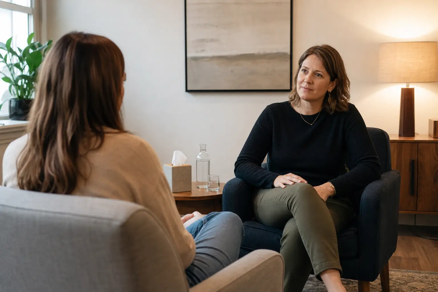 A therapist listening attentively to a client during a private counseling session